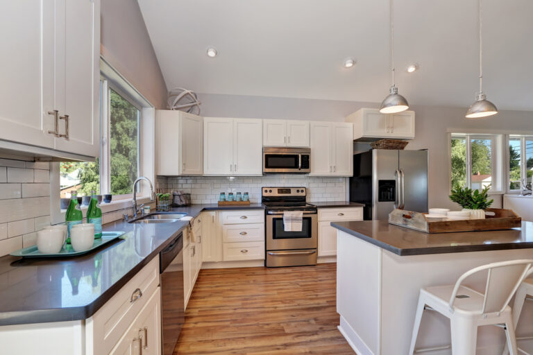 Interior of kitchen room with high vaulted ceiling.